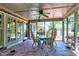 This lovely screened porch features a brick floor, ceiling fan, and wicker dining set at 7204 Bellweather N Ct, Raleigh, NC 27615