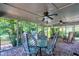 Screened porch features brick floors, ceiling fans, and wicker chairs perfect for outdoor living at 7204 Bellweather N Ct, Raleigh, NC 27615