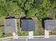 Aerial view of backyard and rooftop; neighborhood of homes with well-kept lawns and mature trees at 77 Rolling Creek Cir, Clayton, NC 27520