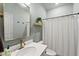 Stylish bathroom featuring a modern mirror, updated vanity, and shower with curtain at 77 Rolling Creek Cir, Clayton, NC 27520