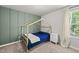 Bedroom featuring a modern playhouse bed and an accent wall at 77 Rolling Creek Cir, Clayton, NC 27520