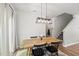 Cozy dining area with a rustic wooden table and modern lighting at 77 Rolling Creek Cir, Clayton, NC 27520