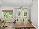 Bright dining room with a rustic wooden table and views of the outdoors at 77 Rolling Creek Cir, Clayton, NC 27520