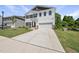 Two-story home with white siding, black shutters, well-manicured lawn and long driveway at 77 Rolling Creek Cir, Clayton, NC 27520