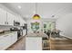 Open-concept kitchen with stainless steel appliances, a granite island, and pendant lighting at 77 Rolling Creek Cir, Clayton, NC 27520