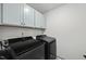 Functional laundry room with modern washer and dryer units at 77 Rolling Creek Cir, Clayton, NC 27520
