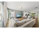 Spacious living room open to the kitchen, featuring a comfortable white sectional and modern light fixture at 77 Rolling Creek Cir, Clayton, NC 27520