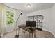 Well lit office with a modern desk, a large window with natural light, and shelving at 77 Rolling Creek Cir, Clayton, NC 27520