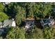 An aerial view of a home with lush greenery, including mature trees and a well-kept lawn at 802 Wakehurst Dr, Cary, NC 27519