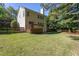 Large backyard with a deck, plenty of trees, and wooden privacy fence at 802 Wakehurst Dr, Cary, NC 27519