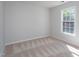 This bedroom has neutral paint, carpet, and a window allowing for plenty of natural light at 802 Wakehurst Dr, Cary, NC 27519