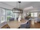Inviting dining room with a modern chandelier and views of the landscaped yard at 802 Wakehurst Dr, Cary, NC 27519