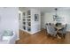 Open-concept space featuring a dining room, hardwood floors, and custom built-ins at 802 Wakehurst Dr, Cary, NC 27519