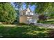 Charming yellow two-story home with a two-car garage and well-maintained landscaping, surrounded by mature trees at 802 Wakehurst Dr, Cary, NC 27519