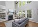 Bright living room with large windows, built-in shelving, and a cozy fireplace at 802 Wakehurst Dr, Cary, NC 27519