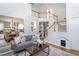 Bright and airy living room featuring staircase and built-in shelving at 802 Wakehurst Dr, Cary, NC 27519