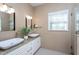Beautiful primary bath with double sinks, granite counters, a large mirror, and plenty of light at 802 Wakehurst Dr, Cary, NC 27519