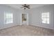 Spacious primary bedroom features neutral paint and carpet with double doors leading to the primary bath at 802 Wakehurst Dr, Cary, NC 27519