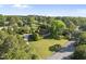 Beautiful aerial view of a home with a curved driveway, lush greenery, and mature trees, offering privacy and charm at 9 Lakeview Dr, Sanford, NC 27332