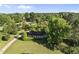 Desirable home surrounded by lush greenery, a curved driveway, and mature trees providing a private and serene setting at 9 Lakeview Dr, Sanford, NC 27332