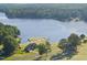 Stunning aerial view of lakefront home, golf course and mature trees at 9 Lakeview Dr, Sanford, NC 27332