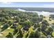 Aerial view of a charming home in a lush, wooded neighborhood with lake views, offering a serene and scenic setting at 9 Lakeview Dr, Sanford, NC 27332