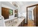 Bathroom featuring double sinks, wood cabinets, a large mirror, and a separate shower stall at 9 Lakeview Dr, Sanford, NC 27332