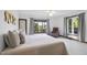 Bright bedroom features large windows with view, ceiling fan, and neutral decor at 9 Lakeview Dr, Sanford, NC 27332