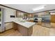 Well-lit kitchen boasting wood cabinets, stainless steel appliances, and a spacious island with seating at 9 Lakeview Dr, Sanford, NC 27332