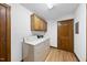 Functional laundry room with washer, dryer, overhead cabinets, and a door leading to another area at 9 Lakeview Dr, Sanford, NC 27332