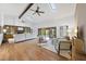 Bright living room with skylights, beamed ceilings, hardwood floors, and comfortable seating arrangements at 9 Lakeview Dr, Sanford, NC 27332