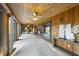 Spacious sunroom with wood ceiling and walls, fan, and view of other rooms at 9 Lakeview Dr, Sanford, NC 27332