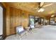Cozy sunroom with wood paneling, ceiling fans, and sliding glass doors at 9 Lakeview Dr, Sanford, NC 27332