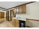Wet bar area with wood cabinets, sink, and laminate flooring, perfect for entertaining guests at 9 Lakeview Dr, Sanford, NC 27332