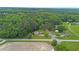 Aerial view of a home surrounded by lush greenery and trees in a serene neighborhood at 901 Currin Perry Rd, Zebulon, NC 27597