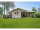 Expansive backyard with lush green lawn, wooden deck, and mature trees provides a private outdoor space at 901 Currin Perry Rd, Zebulon, NC 27597