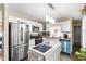Updated kitchen with stainless steel appliances, white cabinets, and modern island with a black countertop at 901 Currin Perry Rd, Zebulon, NC 27597
