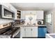 Close-up of a kitchen with stainless steel appliances, granite countertops, and white subway tile backsplash at 901 Currin Perry Rd, Zebulon, NC 27597