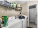 Functional laundry room with washer, dryer, and wire shelving for storage at 901 Currin Perry Rd, Zebulon, NC 27597