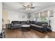 Inviting living room with hardwood floors, sectional sofa, ceiling fan, and plenty of natural light at 901 Currin Perry Rd, Zebulon, NC 27597
