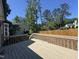 Well-maintained back deck with wood railings and steps down to the backyard at 9013 Tenderfoot Trl, Raleigh, NC 27615