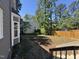 Expansive backyard featuring a wooden fence, lush trees, and a serene outdoor space, perfect for recreation and relaxation at 9013 Tenderfoot Trl, Raleigh, NC 27615