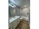 Stylish bathroom with a marble-tiled shower, modern vanity and gold fixtures at 9013 Tenderfoot Trl, Raleigh, NC 27615