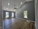 Bright bedroom with vaulted ceilings, a modern ceiling fan, recessed lights, and natural light from three windows at 9013 Tenderfoot Trl, Raleigh, NC 27615