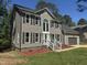 Charming two-story home featuring a well-manicured lawn, gray siding, and an attached garage at 9013 Tenderfoot Trl, Raleigh, NC 27615
