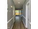 Hallway featuring new floors, fresh paint, and views into adjacent living spaces at 9013 Tenderfoot Trl, Raleigh, NC 27615