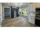 Kitchen showcases modern black cabinetry, white countertops, stainless appliances, and natural light from a window at 9013 Tenderfoot Trl, Raleigh, NC 27615