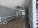 Spacious living room featuring new floors, fresh paint, and updated ceiling fan and light fixture at 9013 Tenderfoot Trl, Raleigh, NC 27615