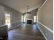 Open living room features a fireplace, high ceilings, and plenty of natural light from the surrounding windows at 9013 Tenderfoot Trl, Raleigh, NC 27615