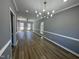 Open-concept living room featuring new floors, fresh paint, and updated light fixtures at 9013 Tenderfoot Trl, Raleigh, NC 27615
